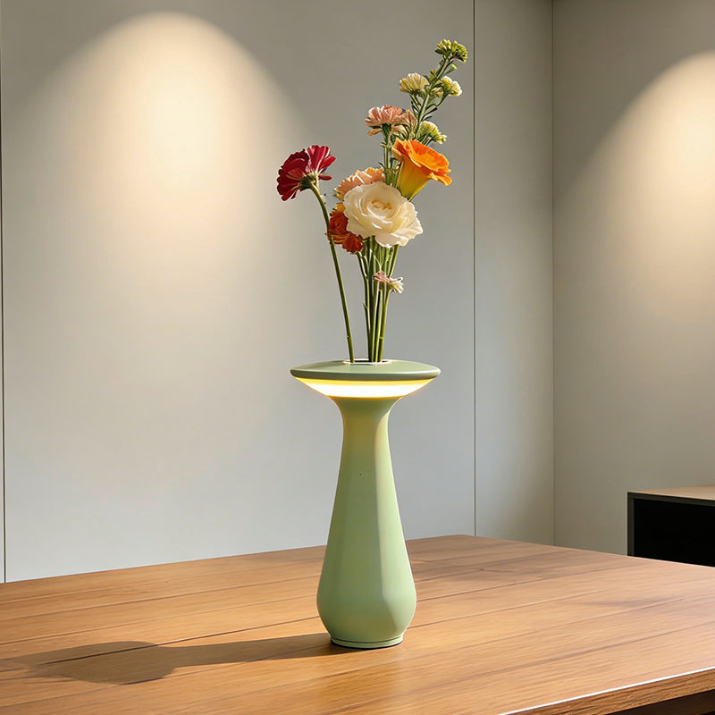 Vase lamp with flowers on a wooden table in daylight