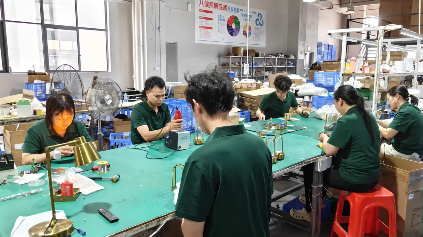 Jianbian Lighting team assembling table lamps at workshop benches